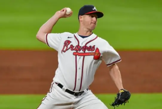 Atlanta Braves Jerseys 8 Atlanta Braves pitcher wearing modern white jersey with red script ‘Braves’ and tomahawk logo across the chest, part of the post-1987 design