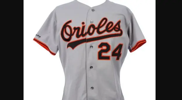 Baltimore Orioles road jersey from 1989–1994 in gray, featuring block ‘Orioles’ lettering with black and orange trim and number 24, marking the era when the realistic ornithologically correct Oriole bird logo replaced the Cartoon Bird.