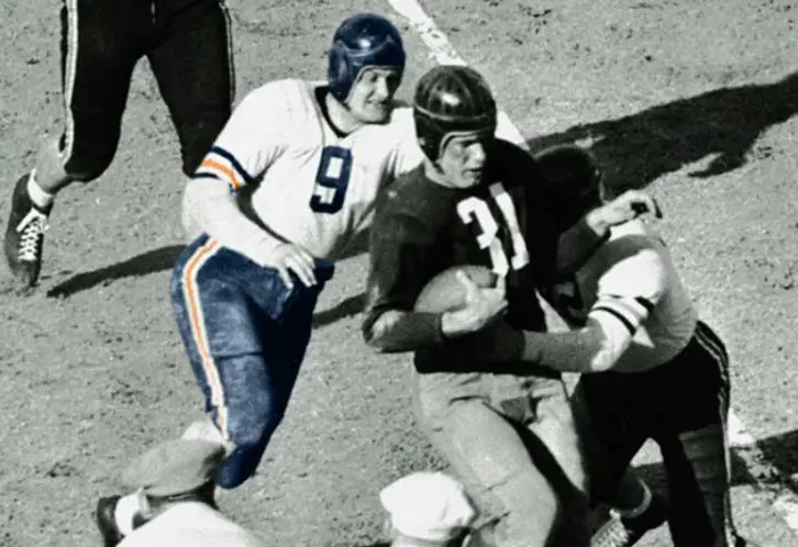1920s Decatur Staleys players in early navy and orange uniforms with vertical stripes — early Chicago Bears football era under George Halas
