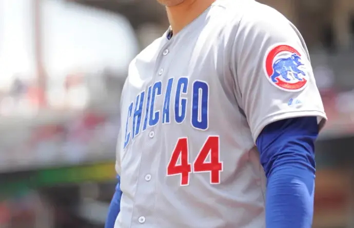 Chicago Cubs Jerseys 1 1990s–Present Chicago Cubs road uniform featuring a gray jersey with blue ‘CHICAGO’ lettering, red player number, and the classic bear-on-a-baseball logo patch on the sleeve