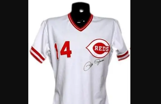 1960s–1990s Cincinnati Reds white pullover jersey featuring the red wishbone ‘C’ logo with ‘REDS’ inside, red trim on the collar and sleeves, and player number 14 on the chest