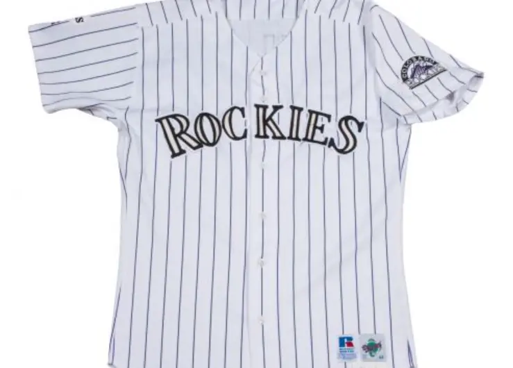 Colorado Rockies Jerseys 4 Colorado Rockies inaugural home jersey featuring white fabric with purple pinstripes, black ‘Rockies’ wordmark across the chest, and team logo patch on the sleeve, representing the team’s original 1993 look
