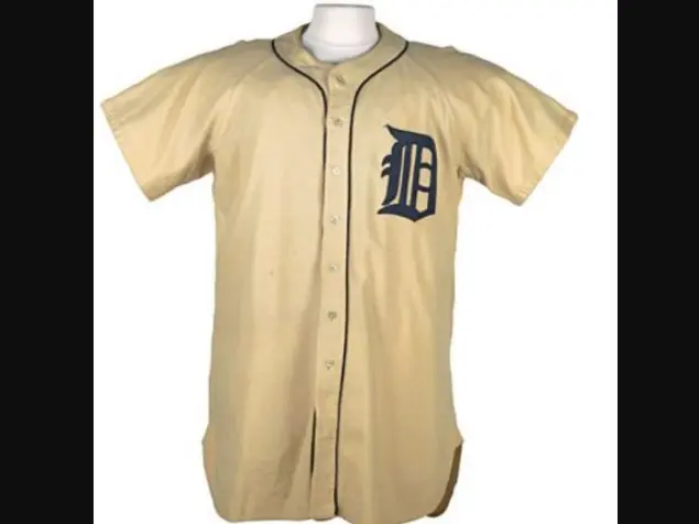 Detroit Tigers jersey from the 1930s–1950s featuring a cream-colored button-down design with the Old English ‘D’ in navy blue on the left chest, representing the classic championship-era look worn during the 1935 and 1945 World Series victories