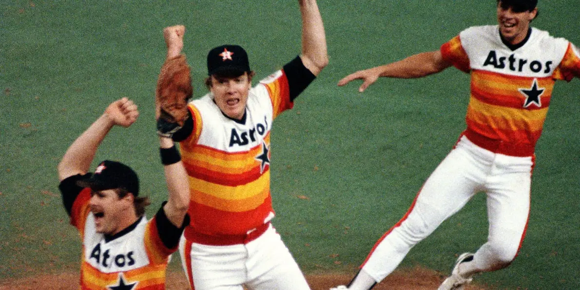 Houston Astros Jerseys 1 Houston Astros players celebrating in white uniforms with orange, red, and yellow stripes on the shoulders, representing the 1987–1993 refined ‘Rainbow Shoulders’ era