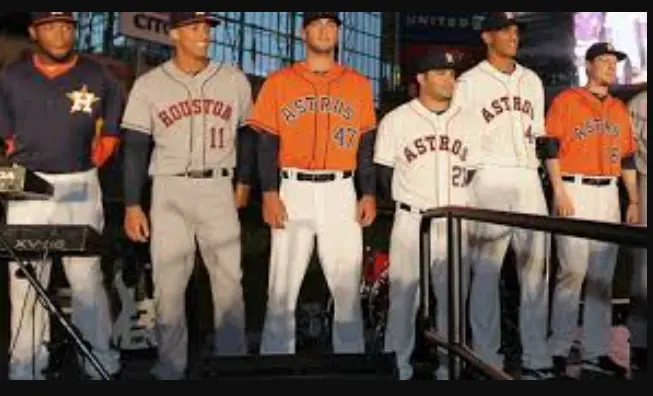 Houston Astros Jerseys 3 Houston Astros players wearing modern orange, gray, and white uniforms with the classic star H logo, representing the 2013–present era of the team’s return to orange and navy blue.
