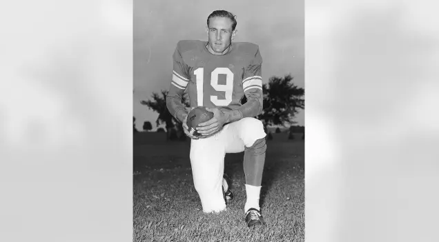 Baltimore Colts player wearing number 19 blue jersey and white pants, posing with a football during the 1953–1983 era