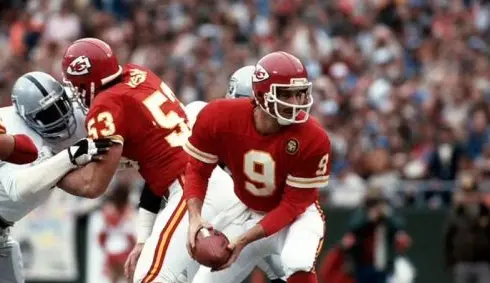 1990s Kansas City Chiefs red and gold uniform with bold sleeve stripes, worn by Derrick Thomas