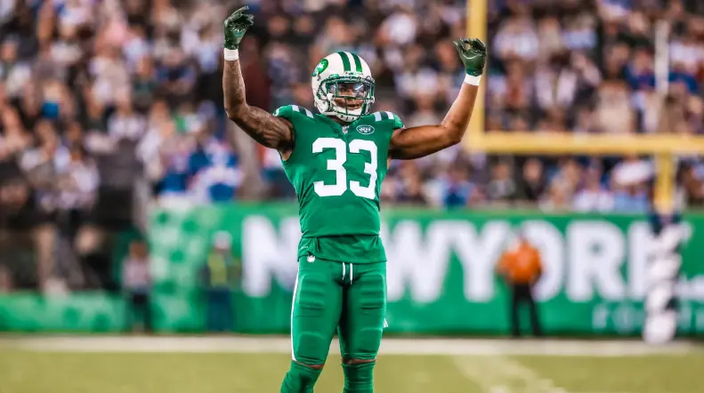 New York Jets player wearing number 33 in the 2019–present Gotham Green uniform during a game