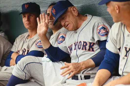 1962–1970s New York Mets players wearing classic gray and white button-up jerseys with royal blue and orange details, showcasing the team’s original pinstripes and iconic ‘Miracle Mets’ era design
