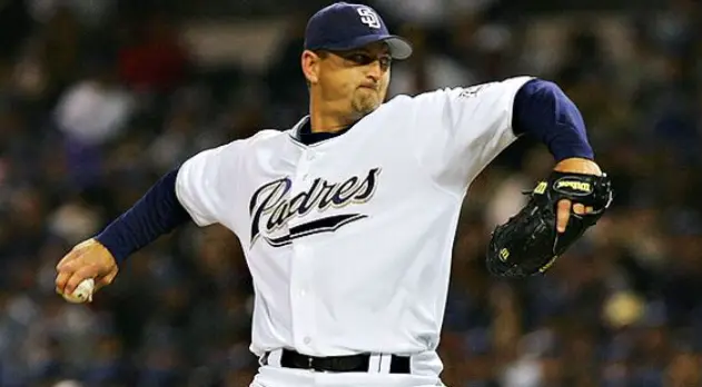 2000s San Diego Padres white jersey with navy sleeves and ‘Padres’ script in navy and sand, worn during the Petco Park and Sand color era