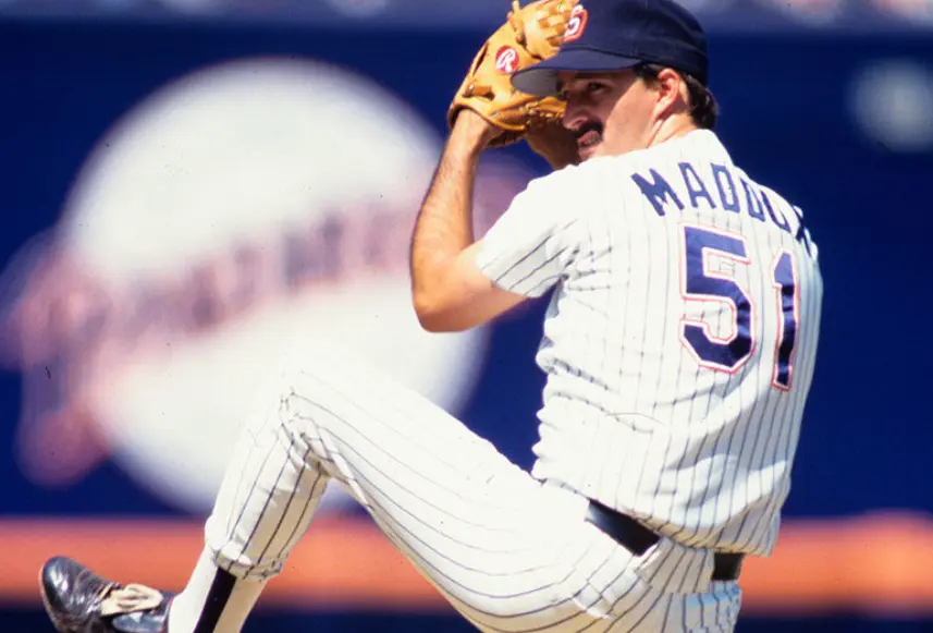 1990s San Diego Padres white jersey with navy pinstripes and navy-and-orange ‘SD’ logo, worn by pitcher in the team’s Navy Blue and Orange era