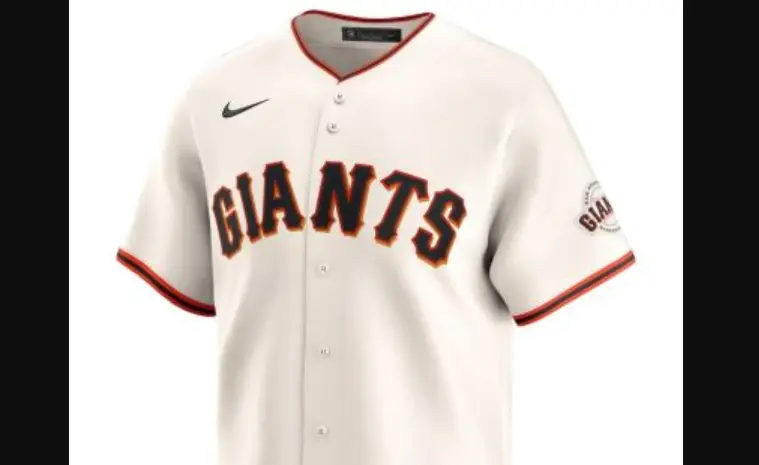 2000–Present San Francisco Giants cream jersey with black ‘GIANTS’ lettering outlined in orange, orange-trimmed collar and sleeves, and team patch on left arm