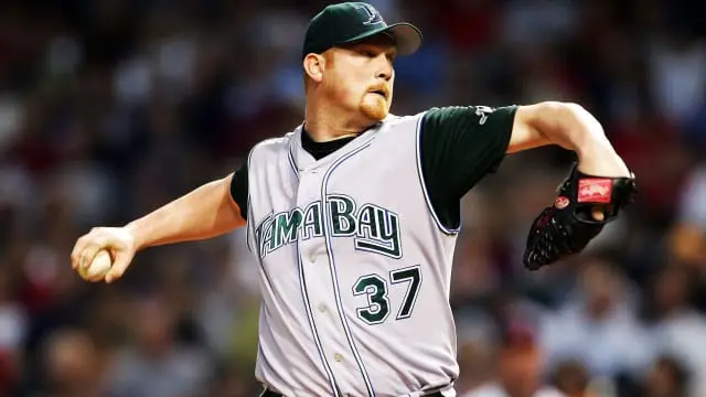 Tampa Bay Devil Rays pitcher wearing the gray uniform with green ‘Tampa Bay’ lettering and black undershirt, representing the 2001–2007 era when the team refined its look with green accents and retired the rainbow gradient script