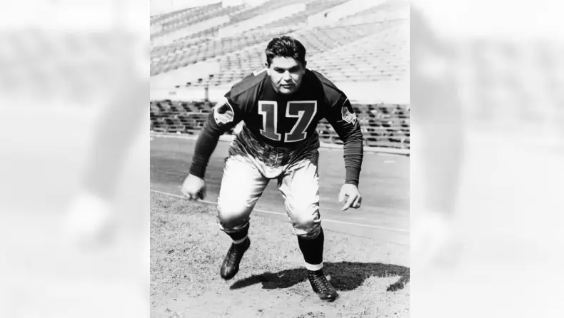 Vintage photo of a Boston Braves football player in 1932 wearing the team’s original blue uniform with red and gold accents, representing the franchise’s earliest identity before becoming the Philadelphia Eagles
